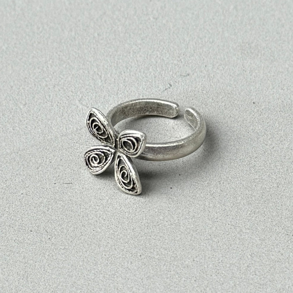 photo of a silver ring with a flower design and an antique style silver finish