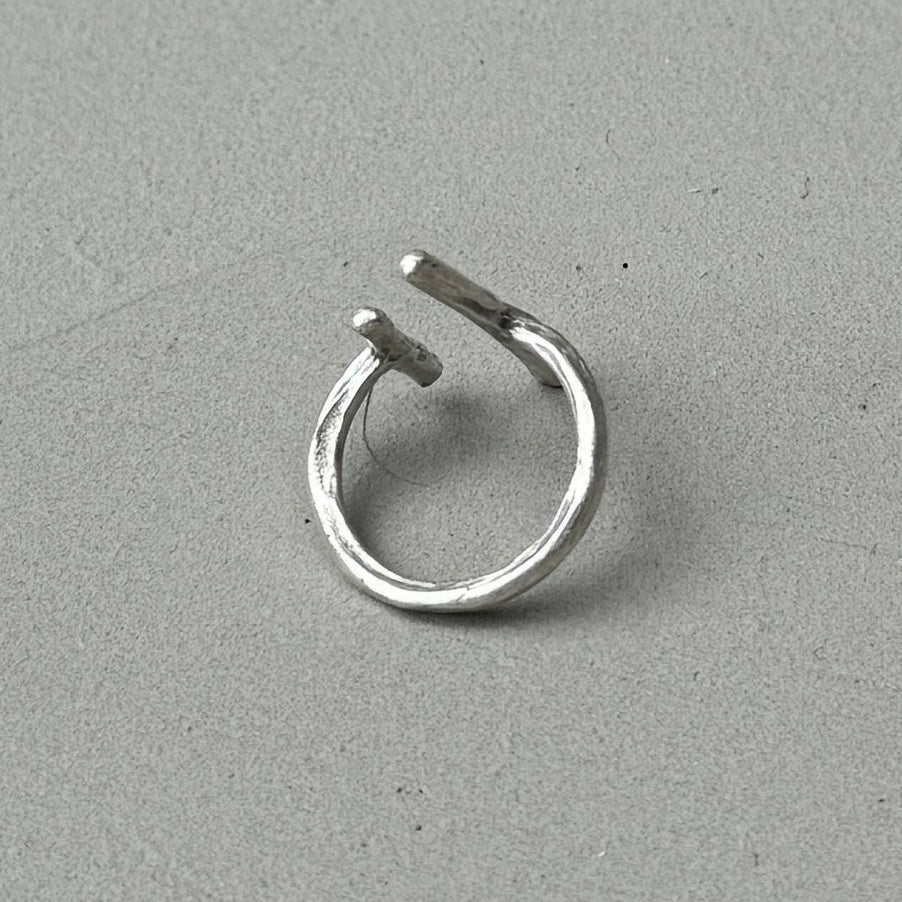 photo of the back of a silver ring with a minimalist 2 lines design