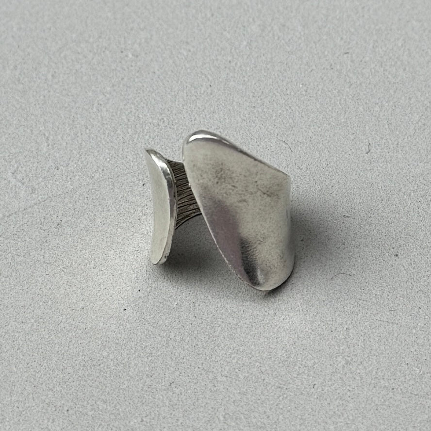 photo of a silver ring with an abstract asymmetric design