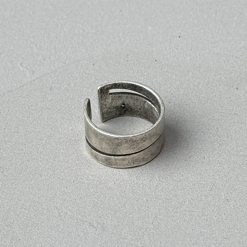 photo of a vintage style silver ring with a cutout diagonal line design