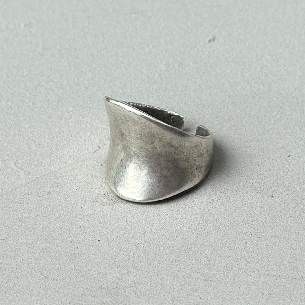 a photo of a silver ring with an oversized asymmetric abstract style and vintage silver finish