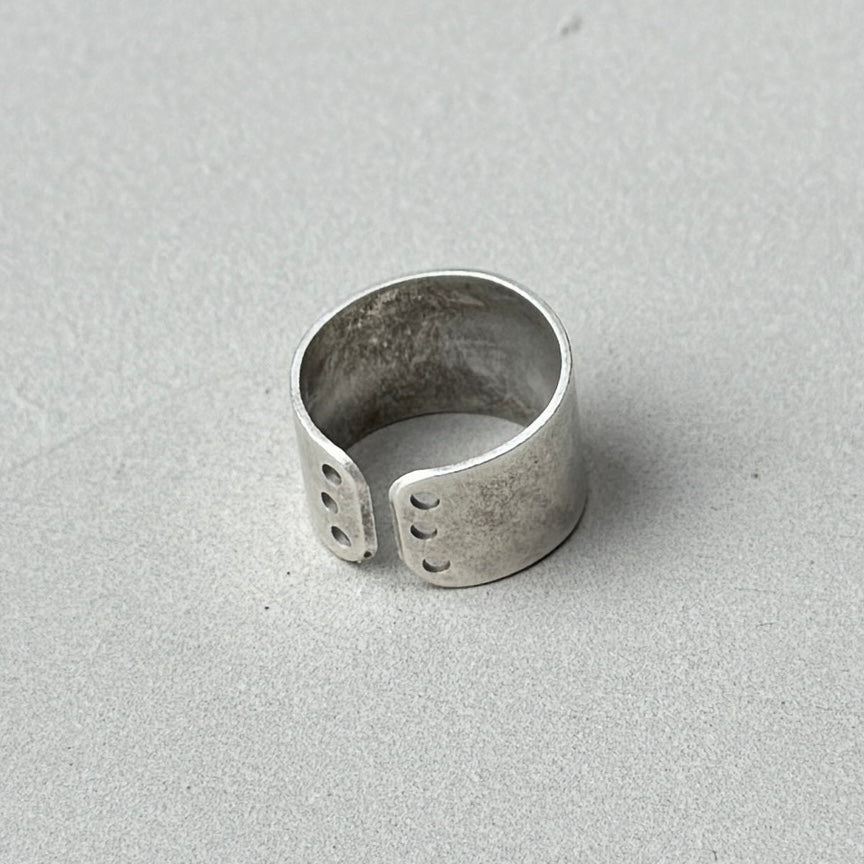 photo of a vintage style silver ring with a circle cutout design