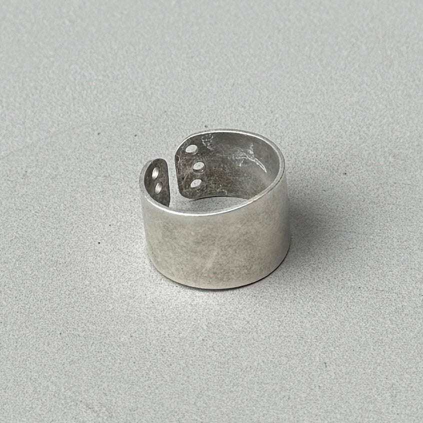 photo of a vintage looking silver ring with a circle cutout design