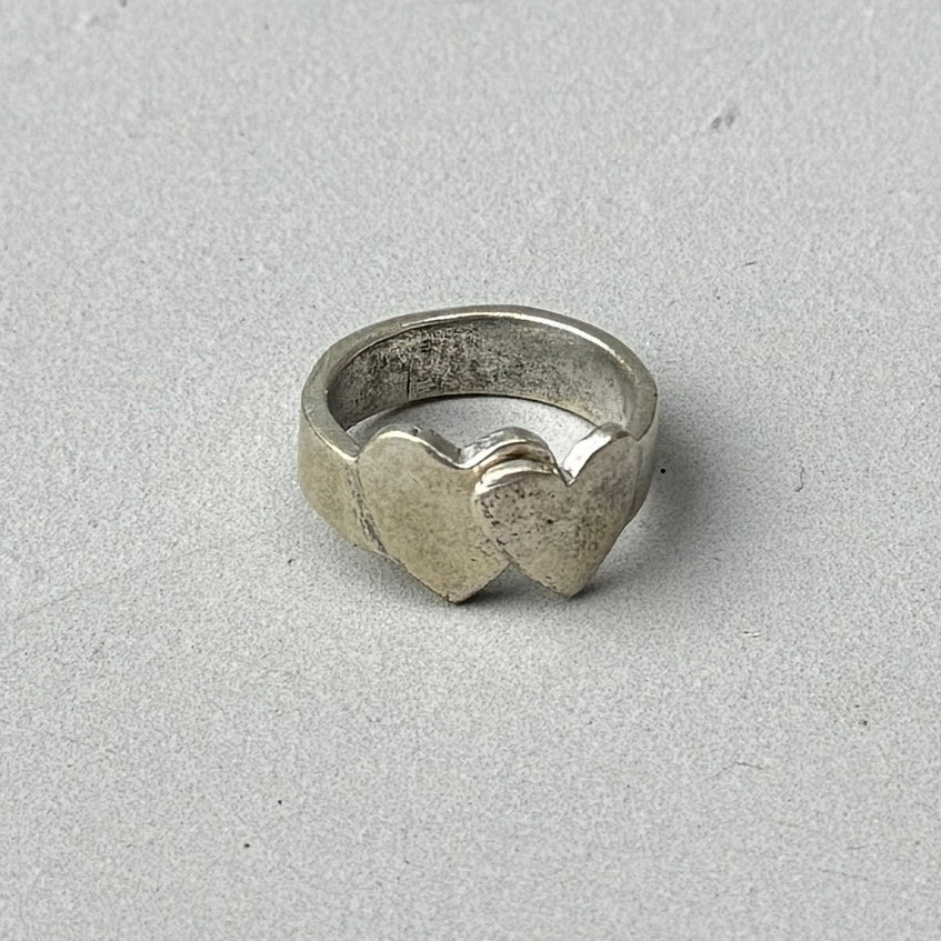 photo of a vintage looking silver ring with a crossed double heart design