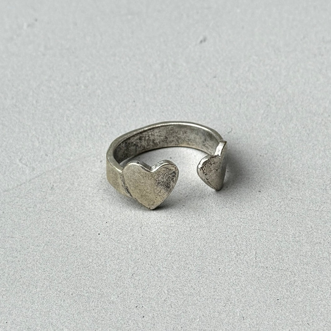 photo of a vintage style silver ring with a crossed double heart design