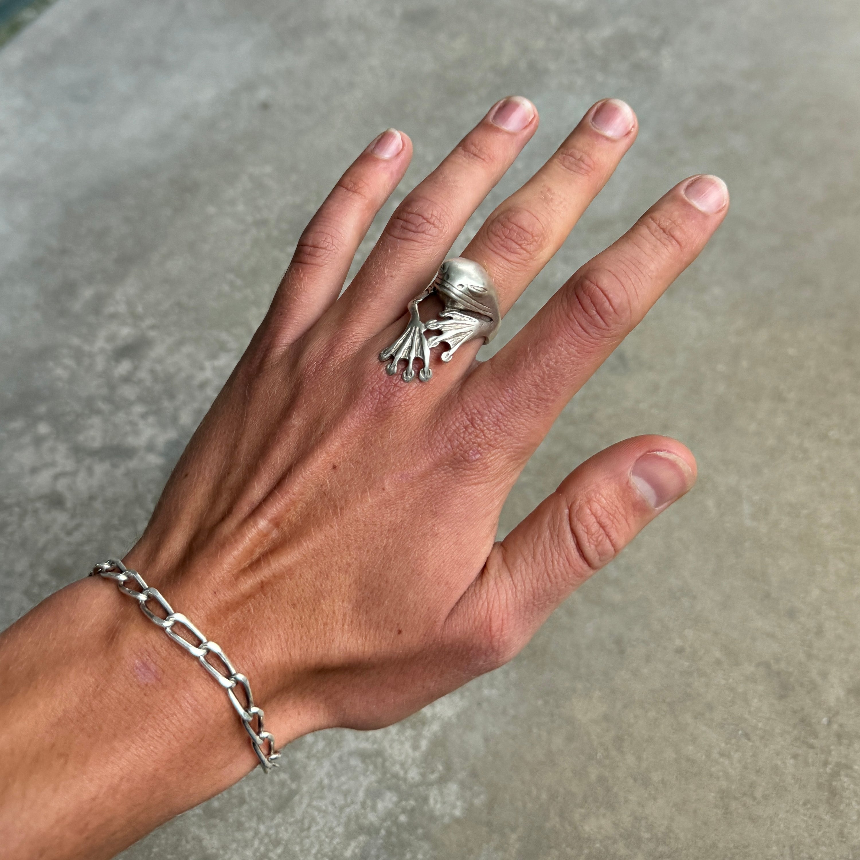 photo of large frog silver ring with antique oxidised silver finish on a hand