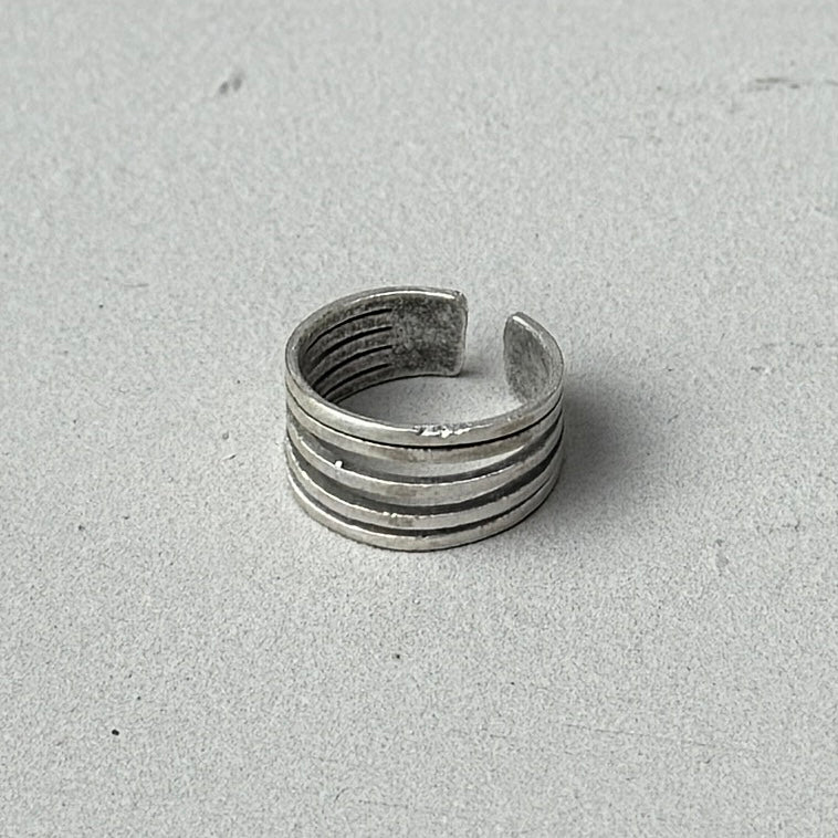 photo of a vintage looking silver ring with 5 lines